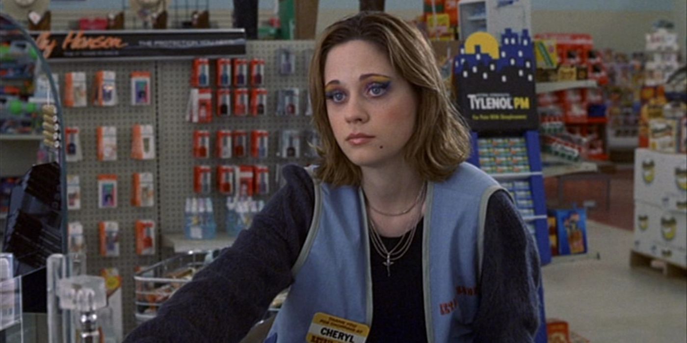 Zooey Deschanel looks bored, working as a cashier at a convenience store in The Good Girl.