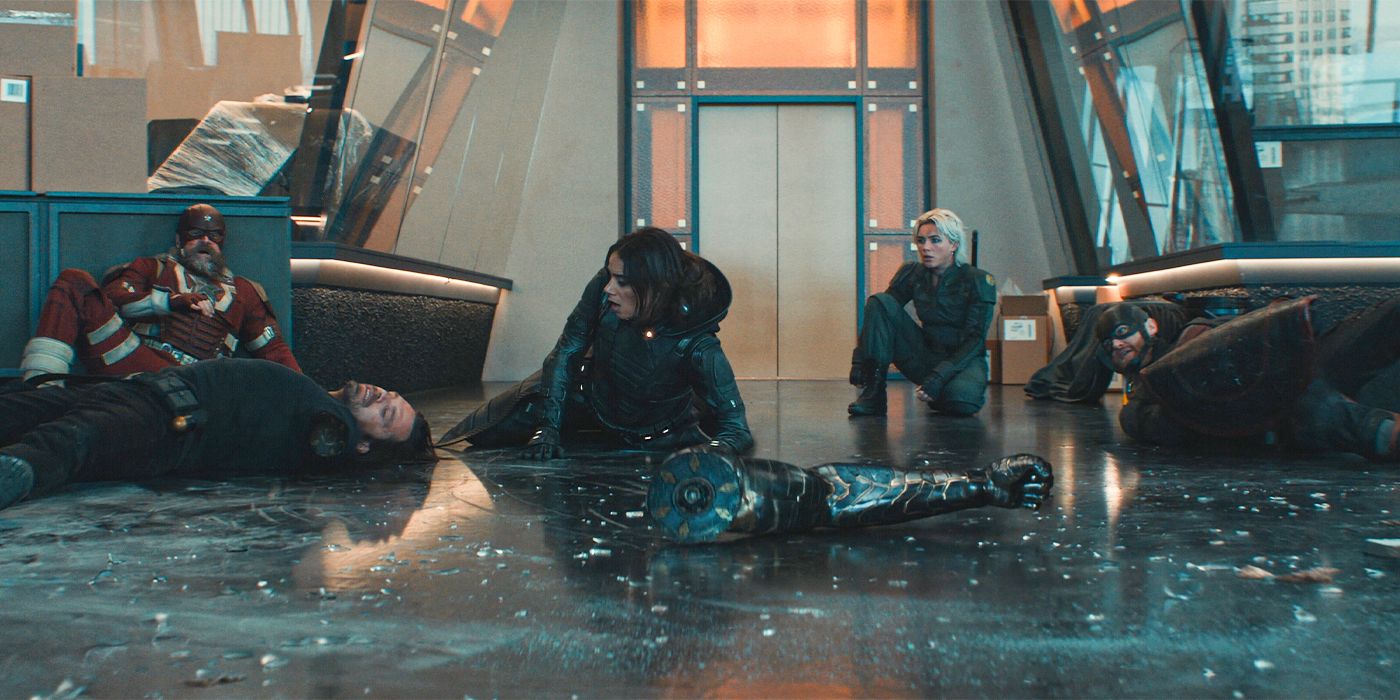 David Harbour as Red Guardian, Sebastian Stan as Bucky, Hannah John-Kamen as Ghost, Florence Pugh as Yelena, and Wyatt Russell as John Walker, lying on the floor surrounded by broken glass in Thunderbolts*.
