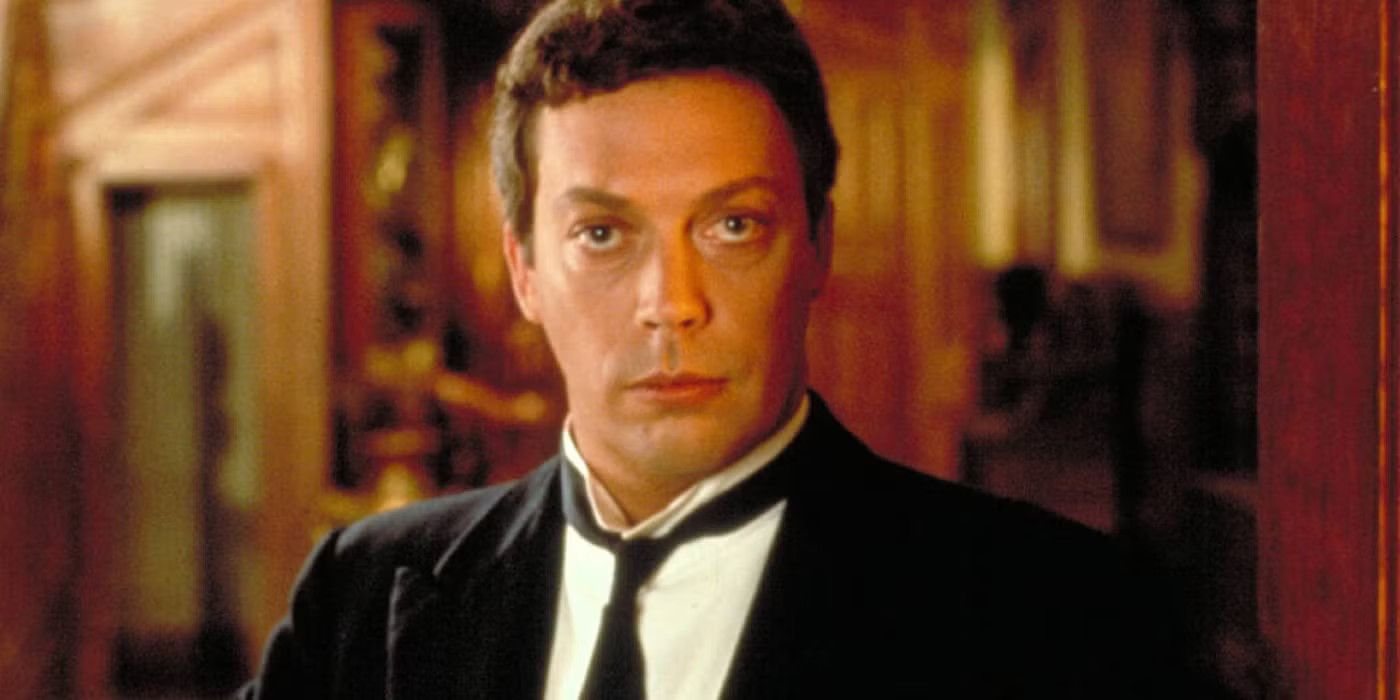 Tim Curry as Wadsworth wears a tuxedo and looks bemused in Clue.