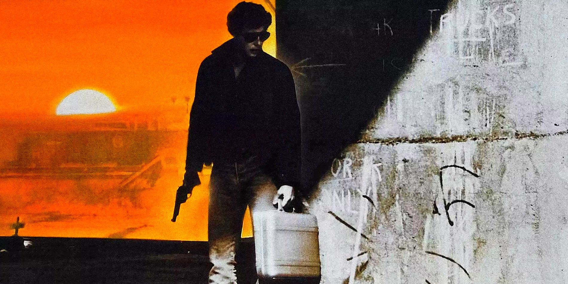 The illustrated figure of a man wearing jeans, a jacket and sunglasses, holding a gun and a briefcase and leaning against a graffitied wall while the sun sets.