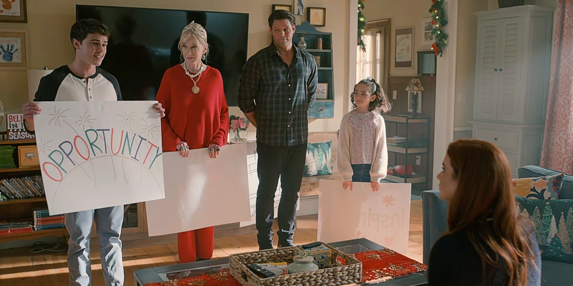 Kyle, Paula, Cal, and Katie holding up signs for Maddie, all turned around except for one that reads "OPPORTUNITY," in the Sweet Magnolias Season 4 finale