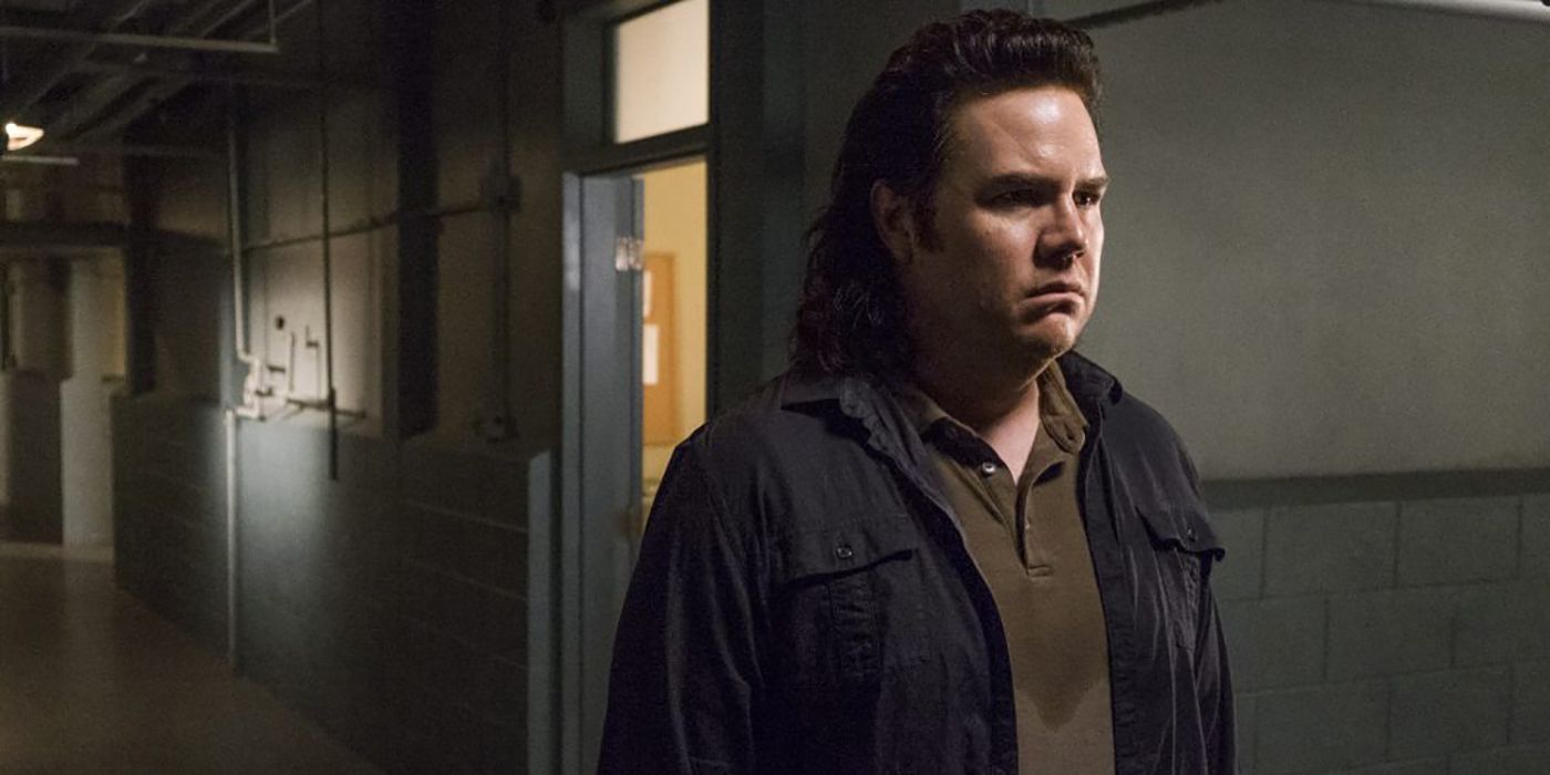 Eugene standing in am empty hallway looking sad in The Walking Dead