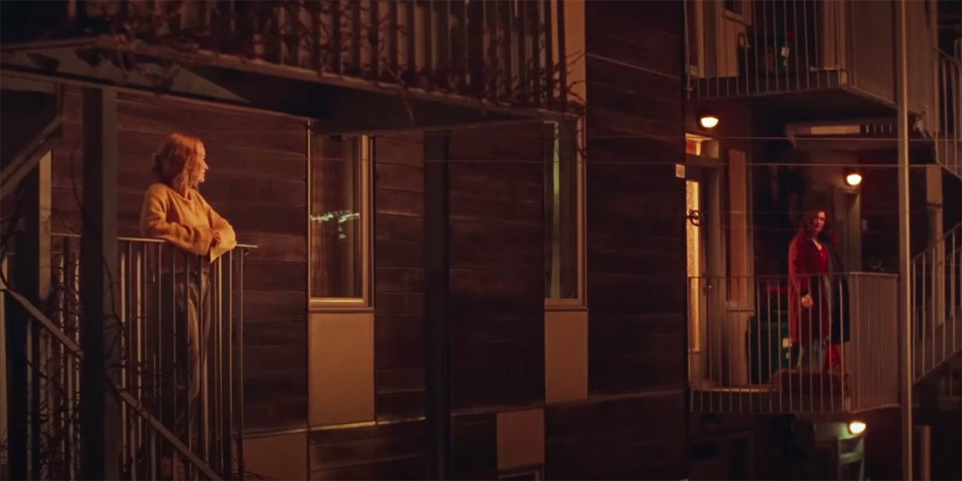 Karine Gonthier-Hyndman and Laurence Labeouf looking at each other on their fire escapes in Two Women