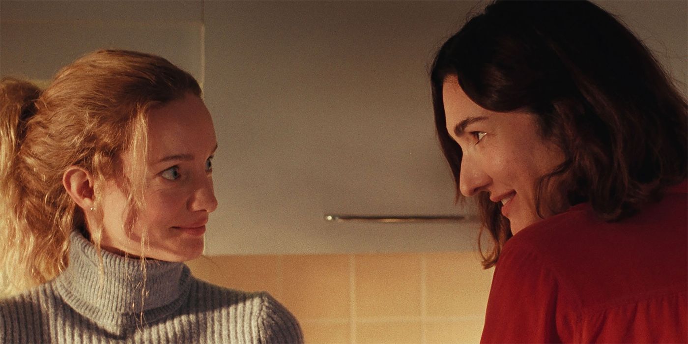Karine Gonthier-Hyndman and Laurence Labeouf looking at each other in a kitchen in Two Women