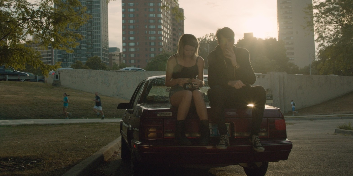 David Dastmalchian and Kim Shaw sitting on a car in Animals