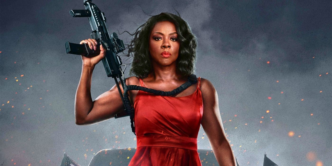 Viola Davis in a red dress with a machine gun in G20