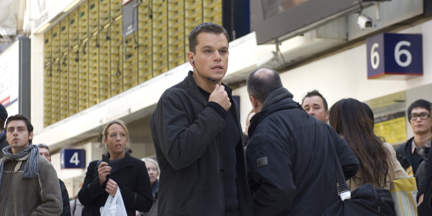 Matt Damon as Jason Bourne stands in a crowded Waterloo Station in The Bourne Ultimatum.