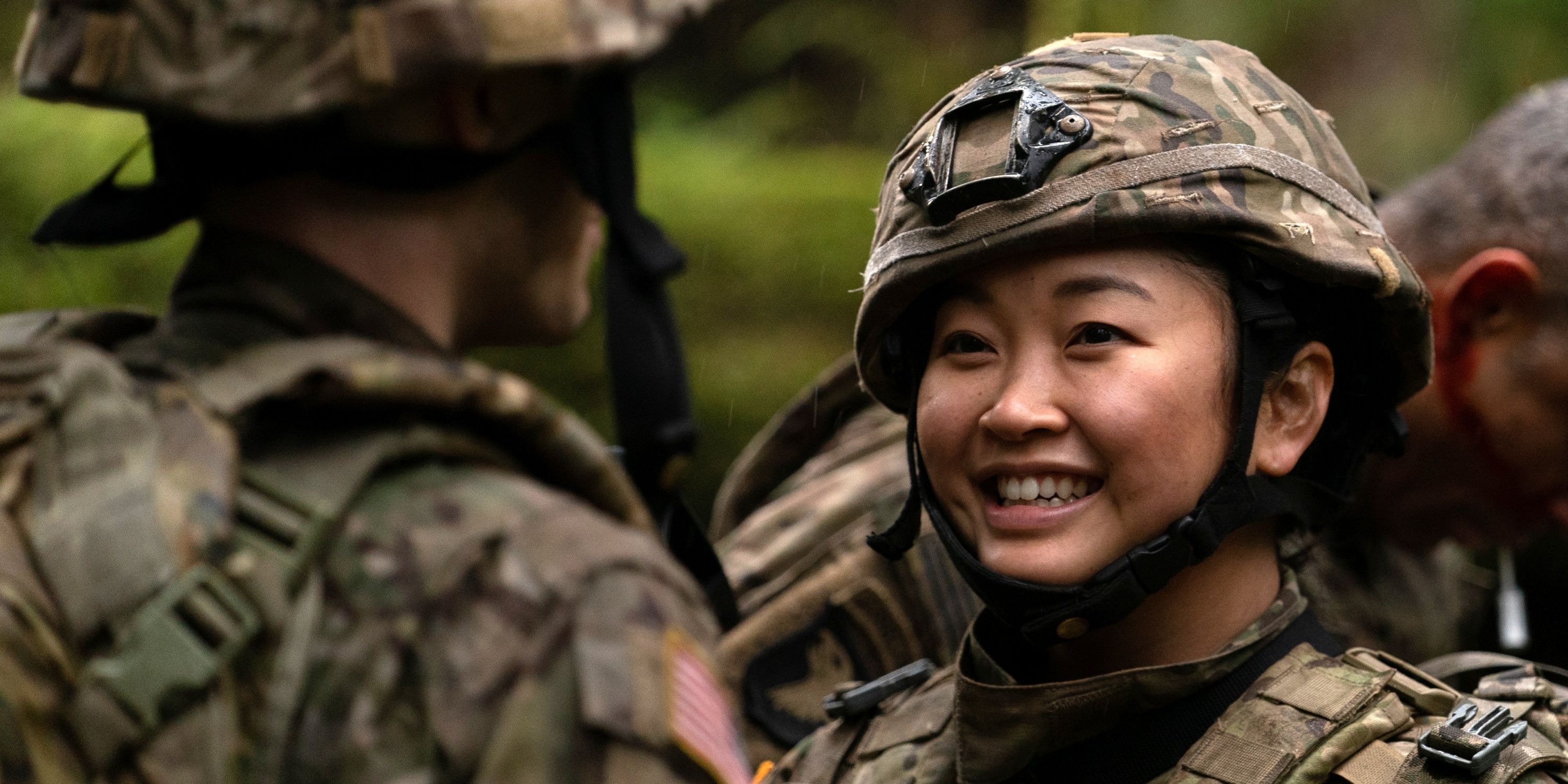 Lana Condor as Selby in her military uniform and helmet smiling in Valiant One