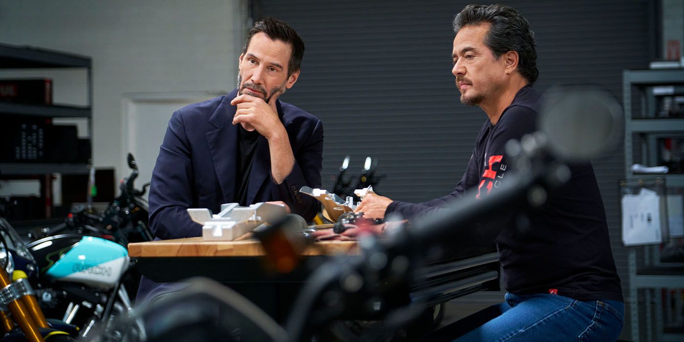 Keanu Reeves and ARCH co-founder Gard Hollinger in their shop sitting at a table
