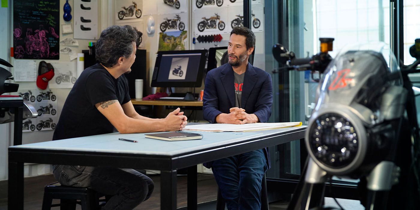 Keanu Reeves and ARCH co-founder Gard Hollinger in their shop sitting at a table
