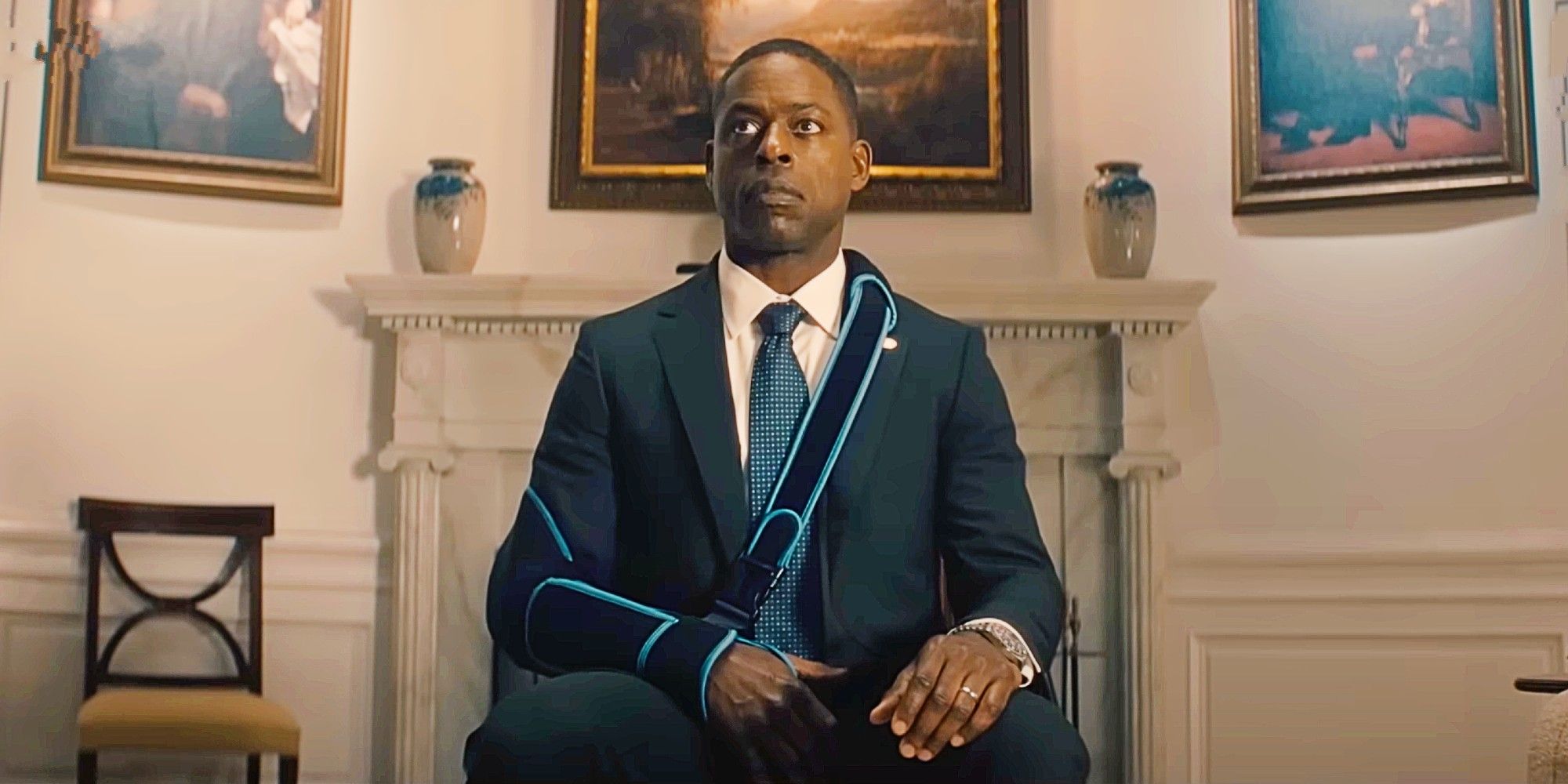 Sterling K. Brown as Xavier Collins in a suit and injured arm in a sling sits in the Oval Office in Paradise.