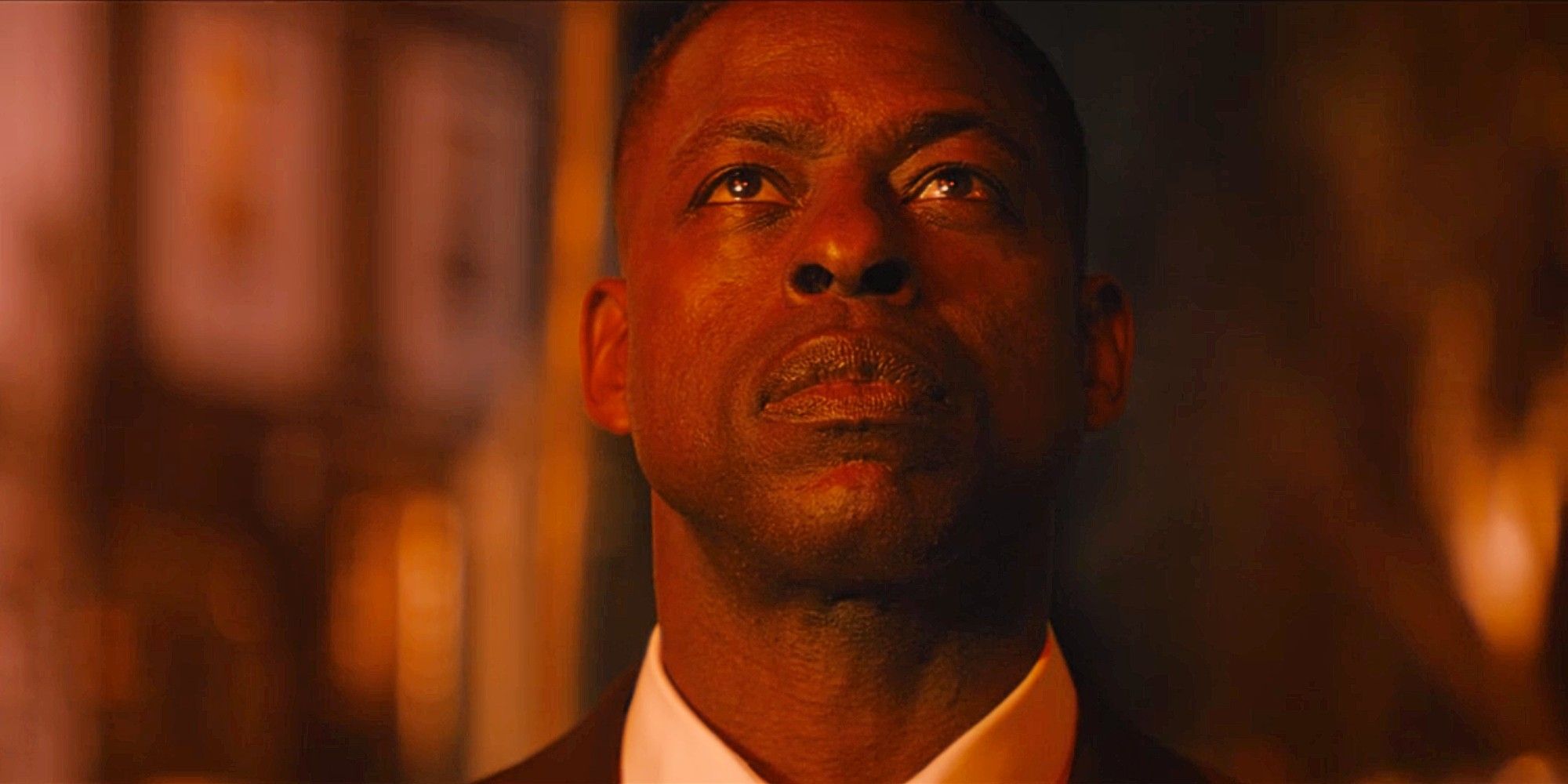 Sterling K. Brown as Xavier Collins looking serious and intentional in Paradise Season 1 Episode 5, while tinted in red light