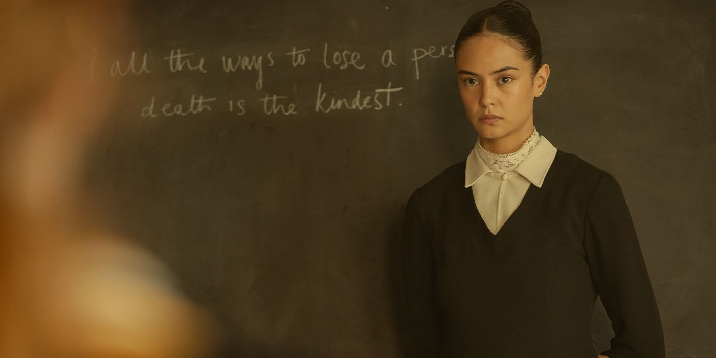 Lottie in front of a blackboard that says "Of all the ways to lose a person death is the kindest."