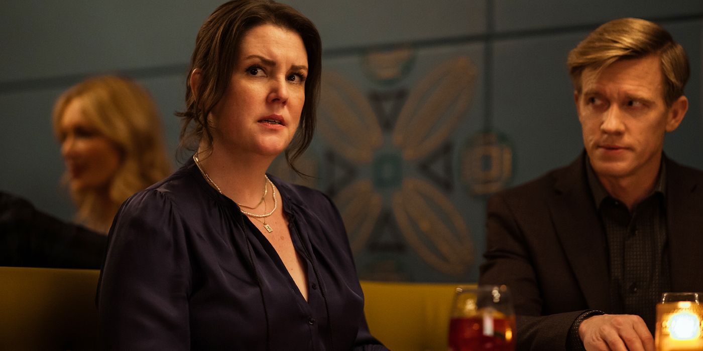 Shauna looking anxiously to the side in a booth next to Jeff at a restaurant in Yellowjackets Season 3
