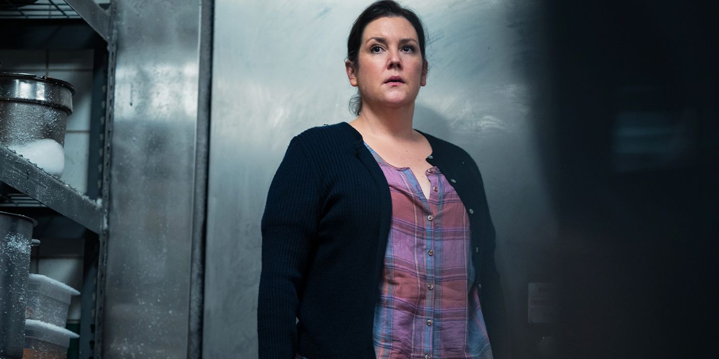 Shauna (Melanie Lynskey) in a freezer looking off-camera fearfully in Yellowjackets Season 3