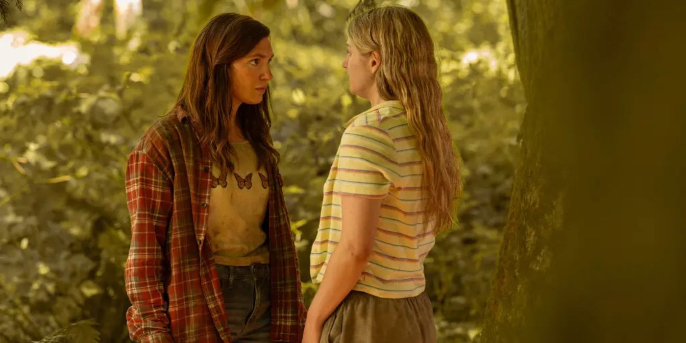 Sophie Nélisse and Jenna Burgess as Shauna and Melissa, looking at each other in the forest in Yellowjackets