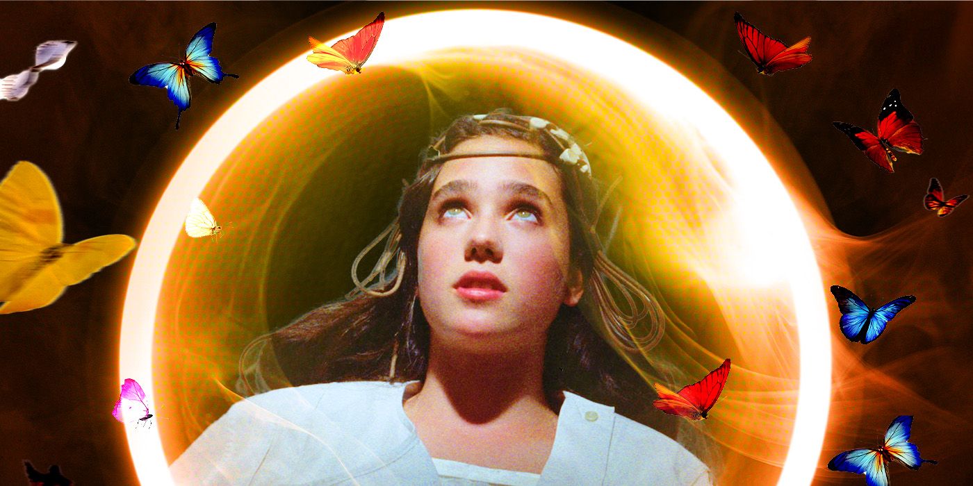 Jennifer Connelly as Jennifer in Phenomena, with electrodes attached to her head and a bright light glowing behind her as butterflies fly around.