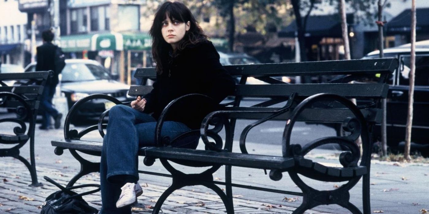 Zooey Deschanel sits on a bench outside and looks sullen in Winter Passing.