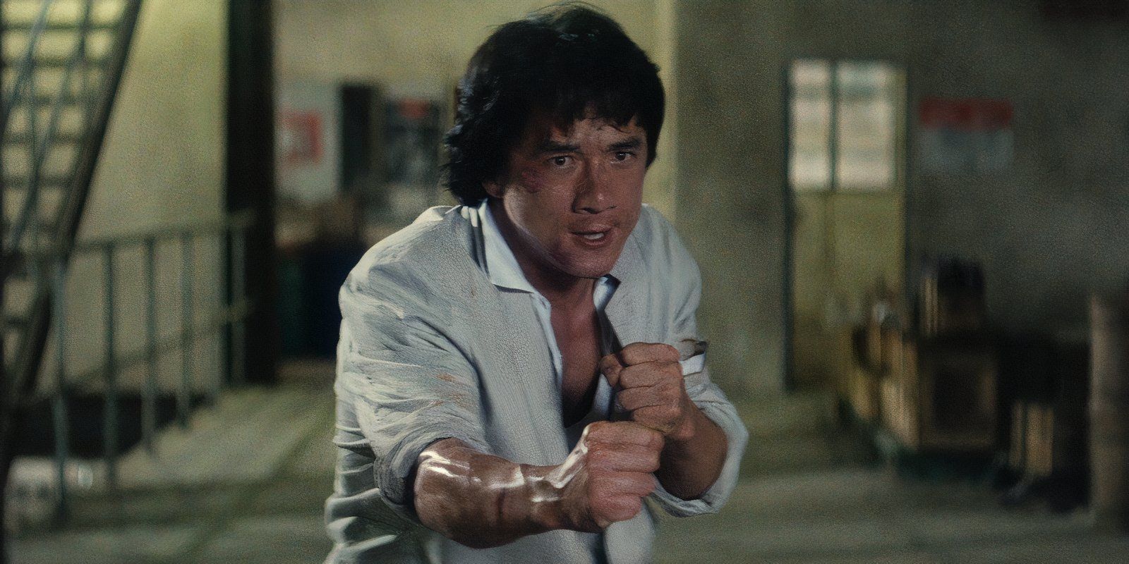 Jackie Chan with his fists up, ready to fight, in Police Story 2