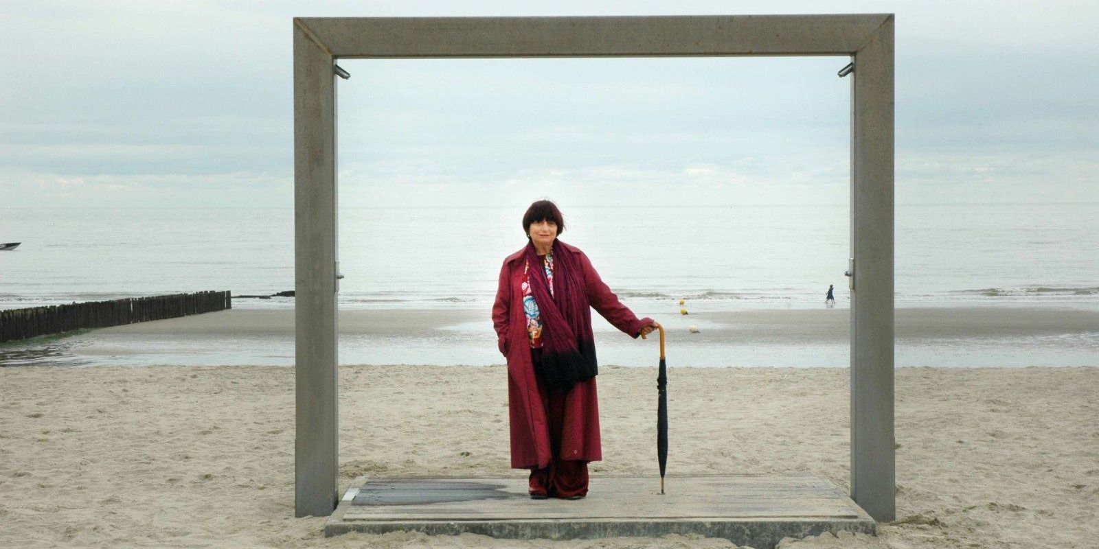 Agnès Varda under a wooden frame on the beach in &lsquo;The Beaches of Agnès&rsquo;