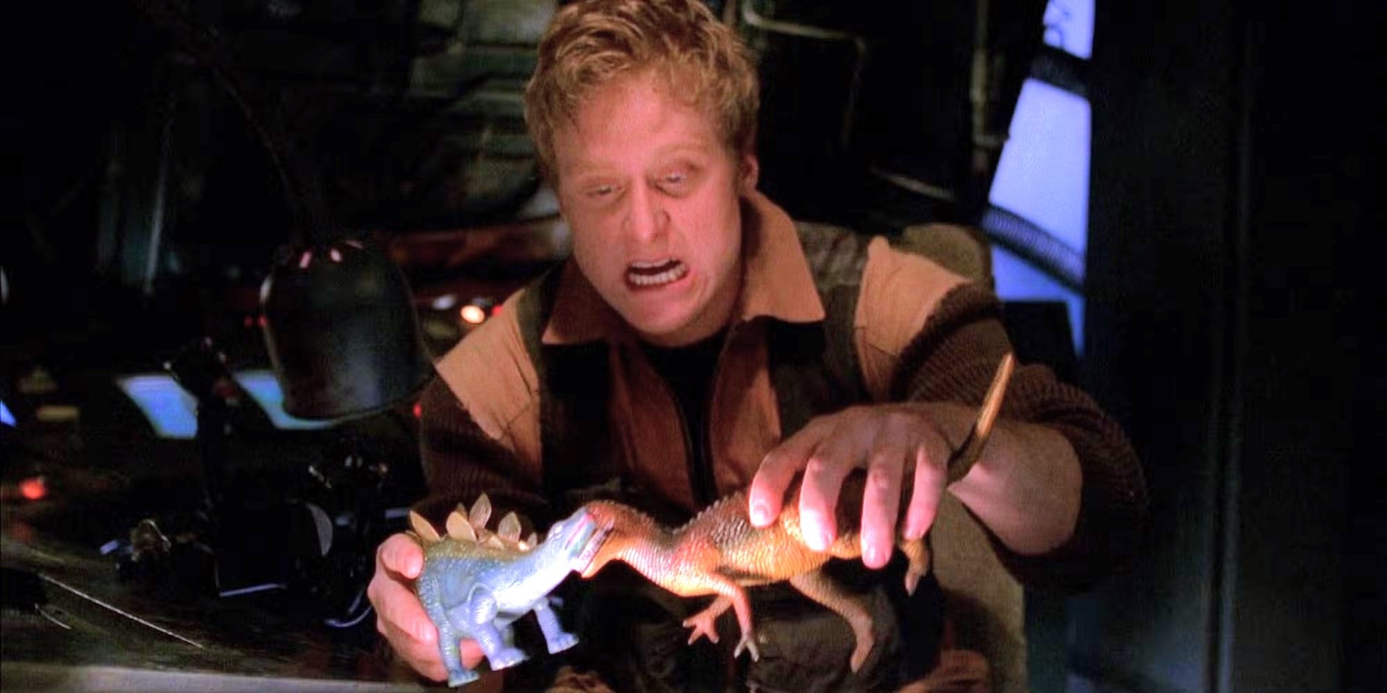 Alan Tudyk as Wash playing with toy dinosaurs in the cockpit of the ship on Firefly.