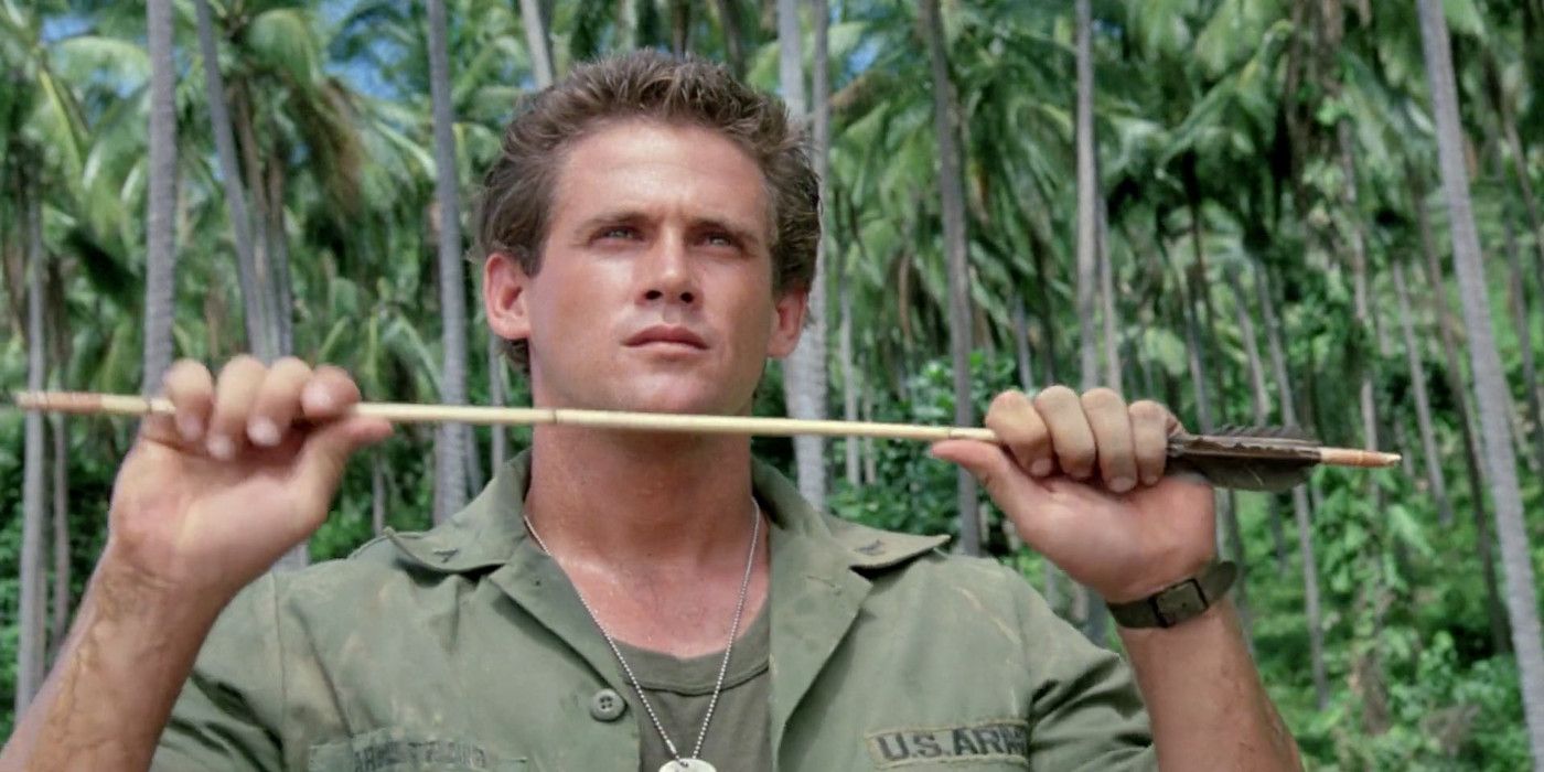 Michael Dudikoff as Joe holds an arrow in a jungle in American Ninja.