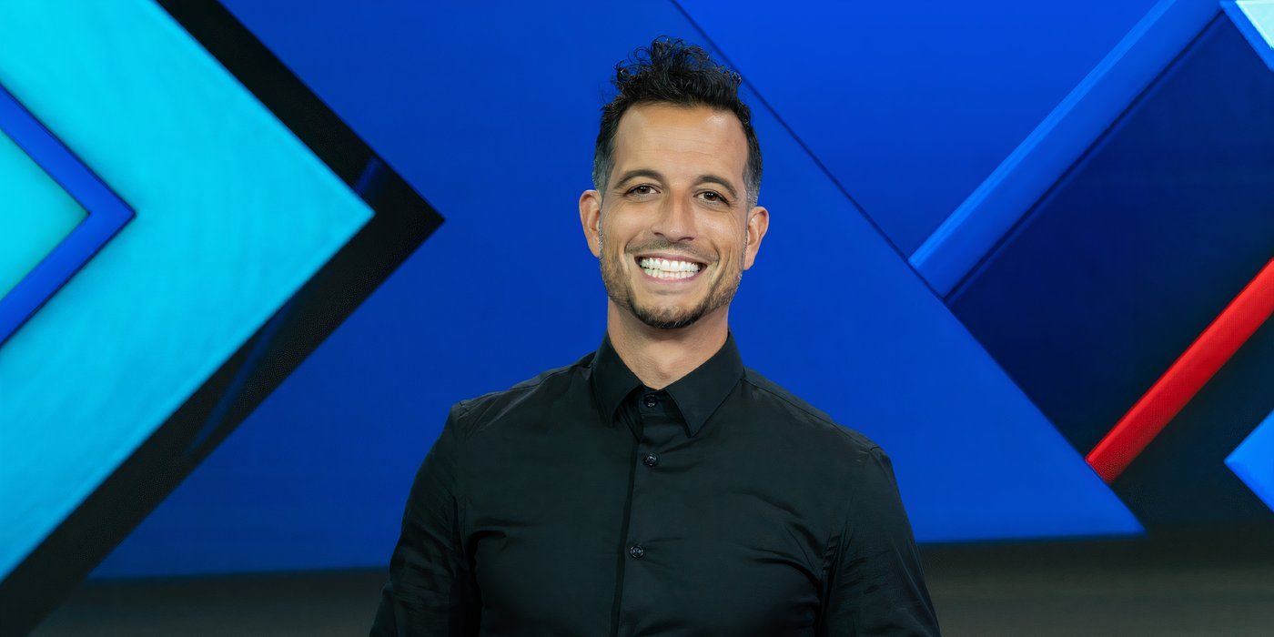 Tony Reali standing on the stage for ESPN's sports commentary show Around the Horn