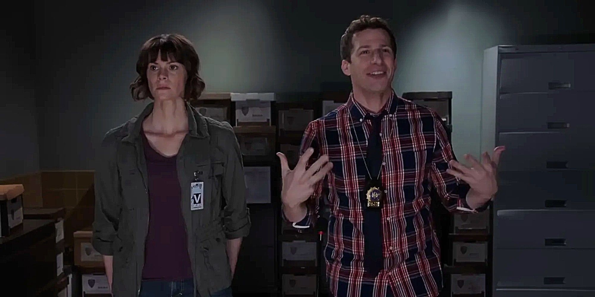 Jake Peralta happily stands next to an upset woman in Brooklyn Nine-Nine Season 5