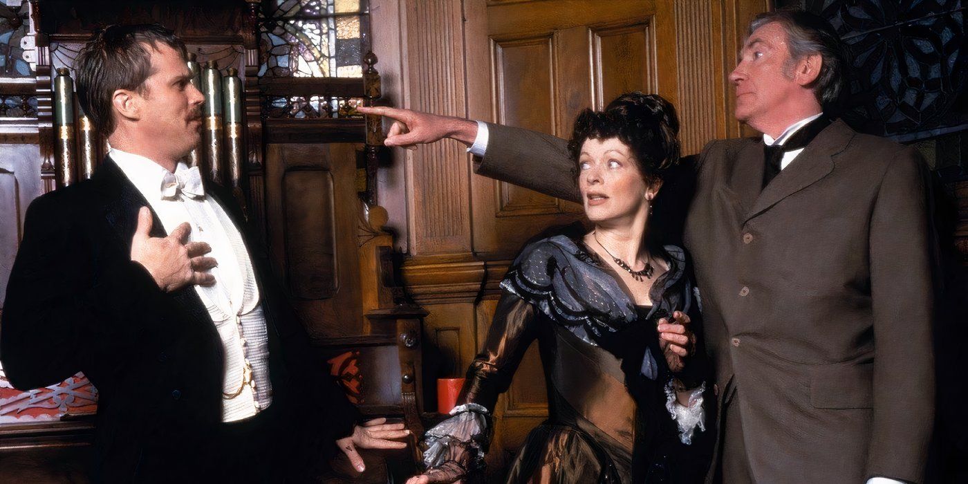 An older, distinguished man points his finger at a man in a tuxedo as a woman looks on The Outer Limits. 