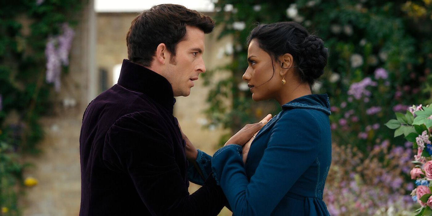 A man and woman stare intimately at each other as they stand outside and hold hands in Bridgerton.