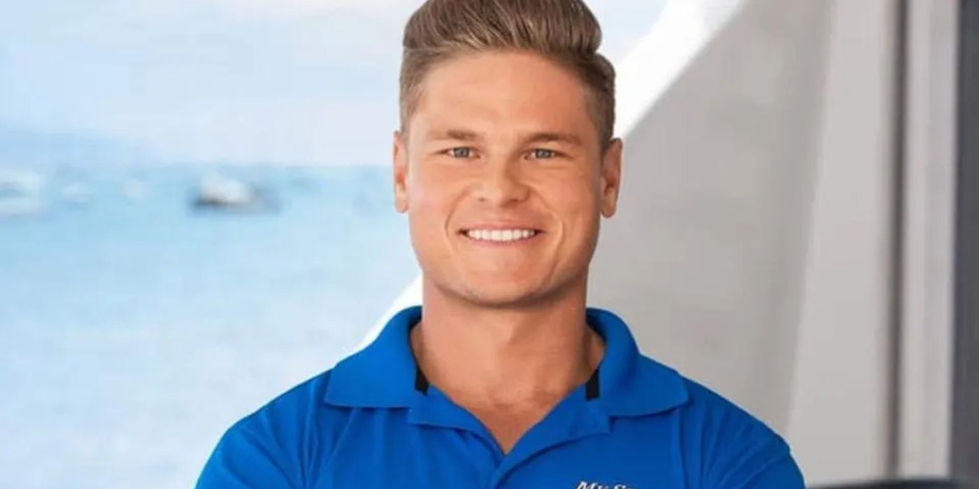 Ashton Pienaar smiles at the camera with a nautical background in a promo photo for &lsquo;Below Deck.'