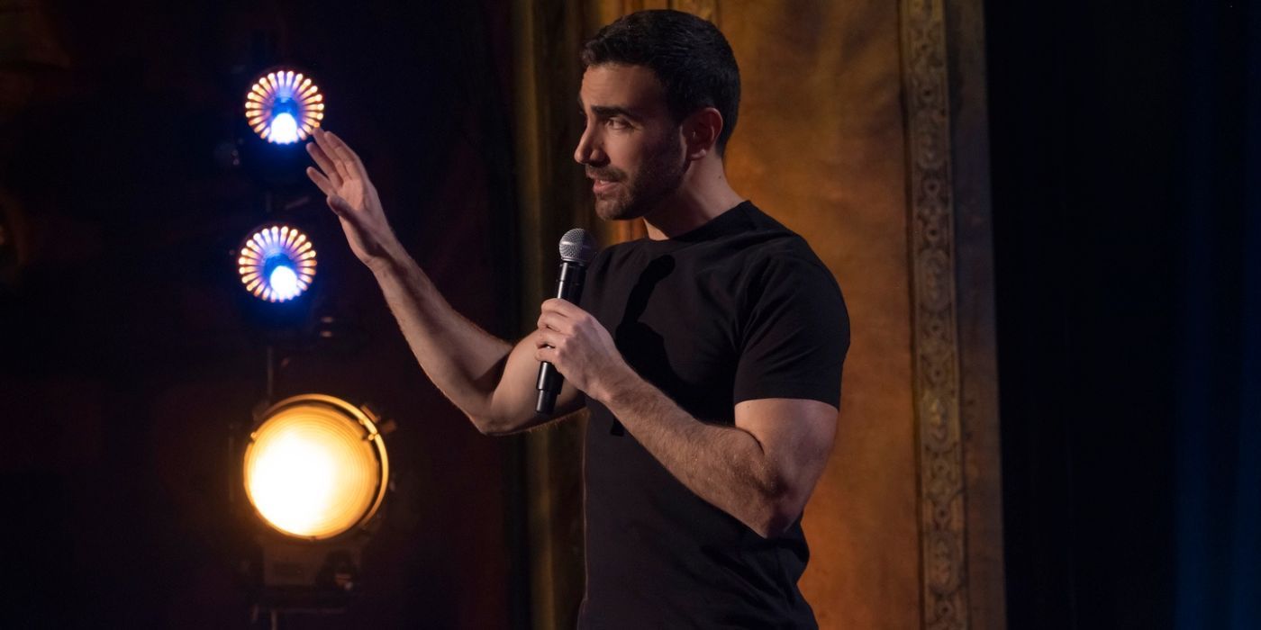 Brett Goldstein performing with a microphone in The Second Best Night of Your Life.