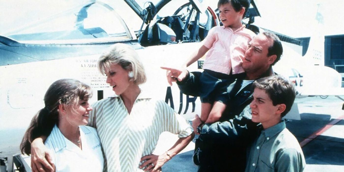 A family stands by a plane, the dad pointing in Call to Glory.