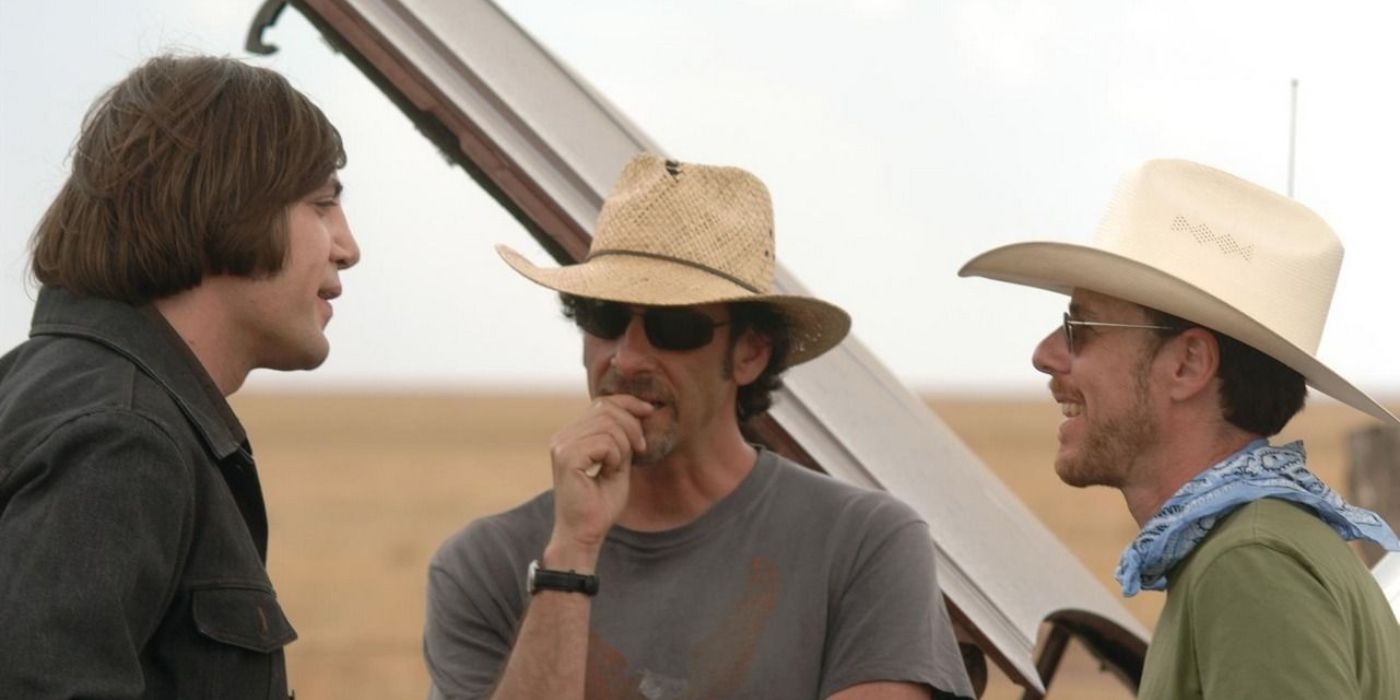 Directors Joel and Ethan Coen talk to actor Javier Bardem on the set of No Country for Old Men.