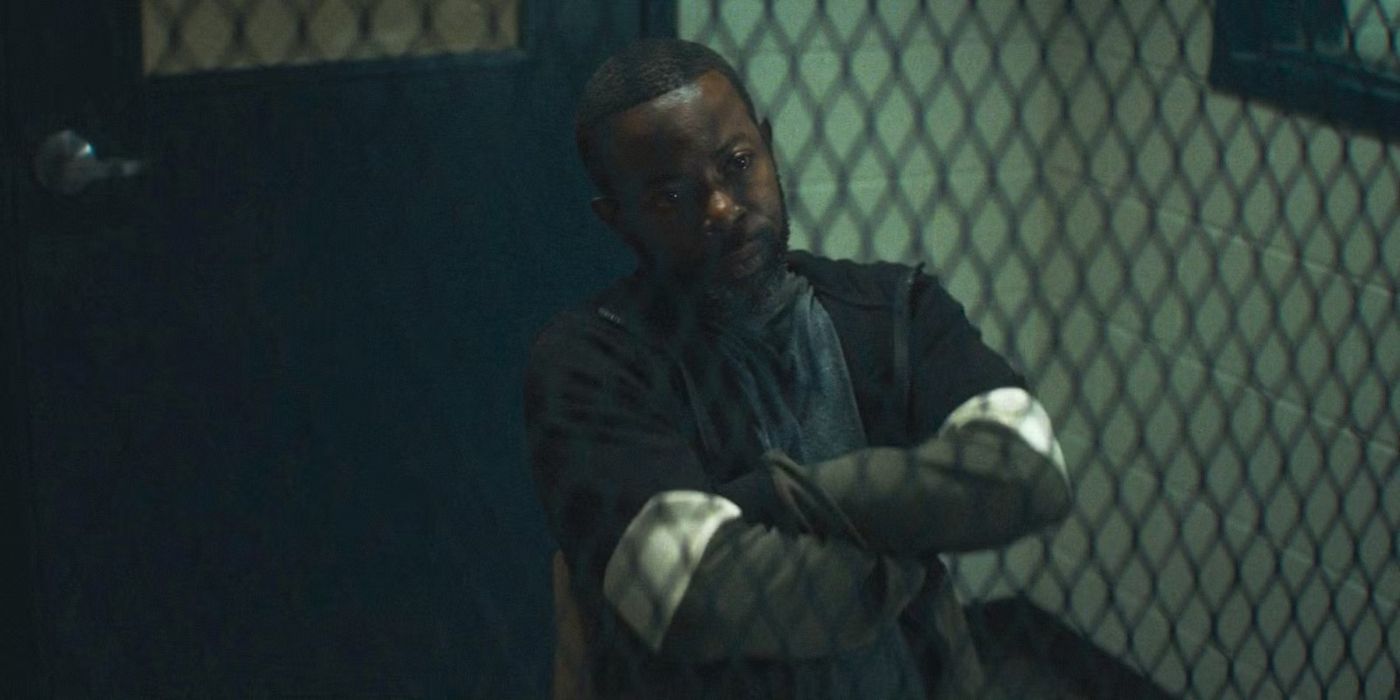 Leroy (Charlie Hudson III) sitting with his arms crossed behind glass in a holding area in Daredevil: Born Again