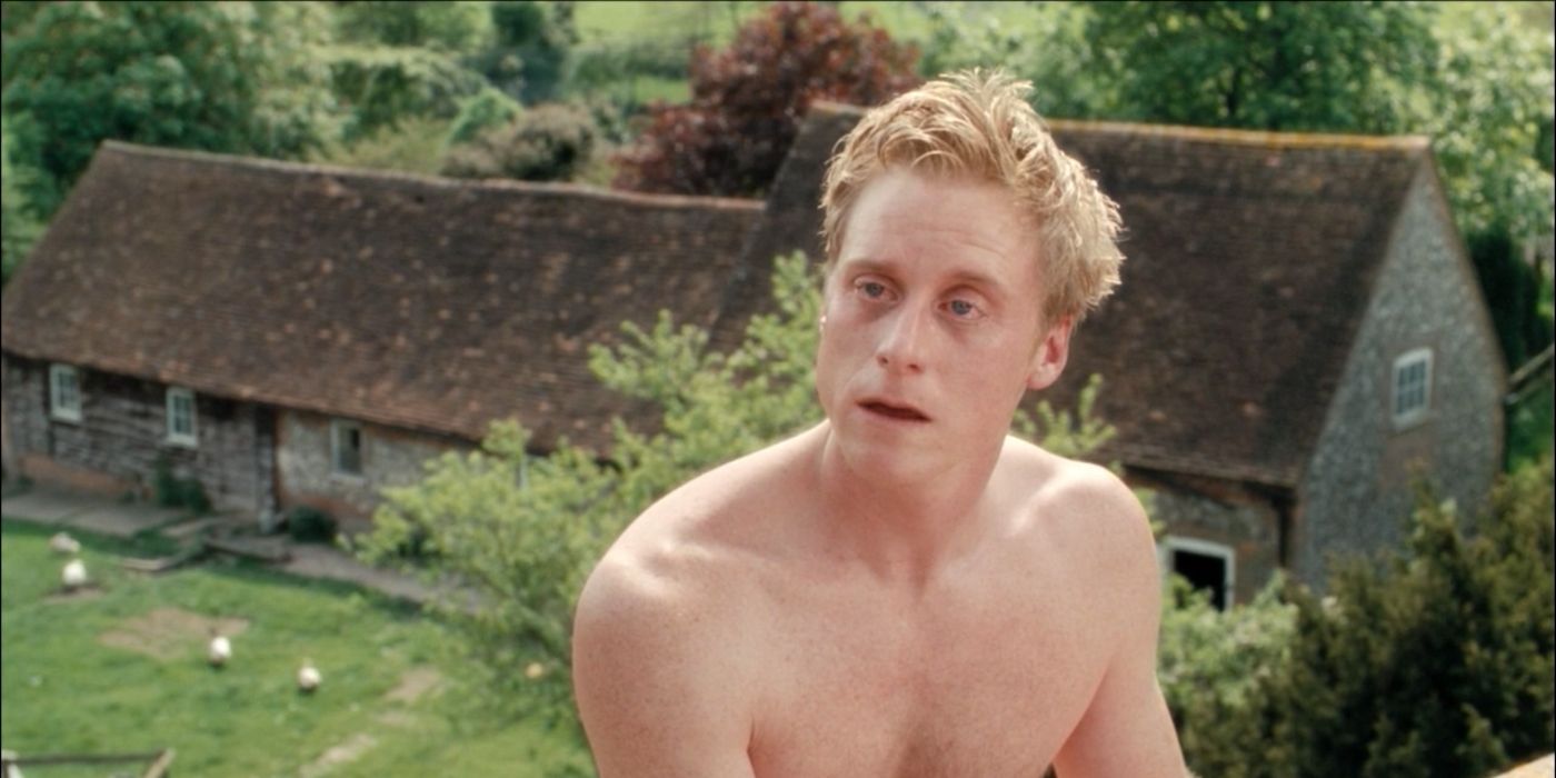 Alan Tudyk as Simon, sitting naked on a roof in Death at a Funeral.