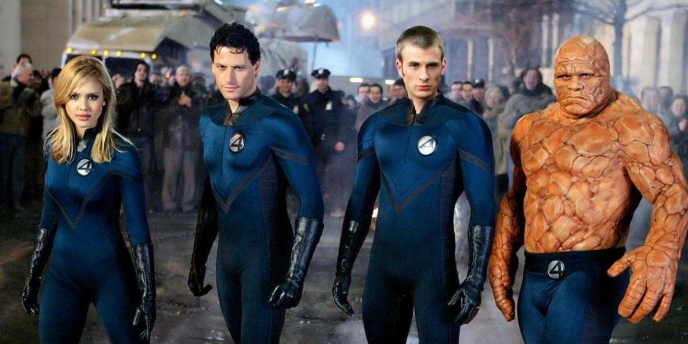 Sue Storm, Reed Richards, Johnny Storm and The Thing stand together with civilians watching them