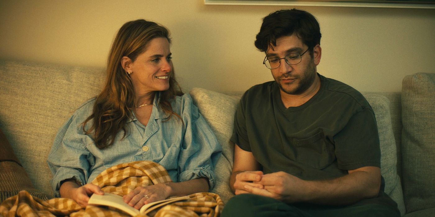 Amanda Peet smiling on a couch at Matthew Shear in Fantasy Life