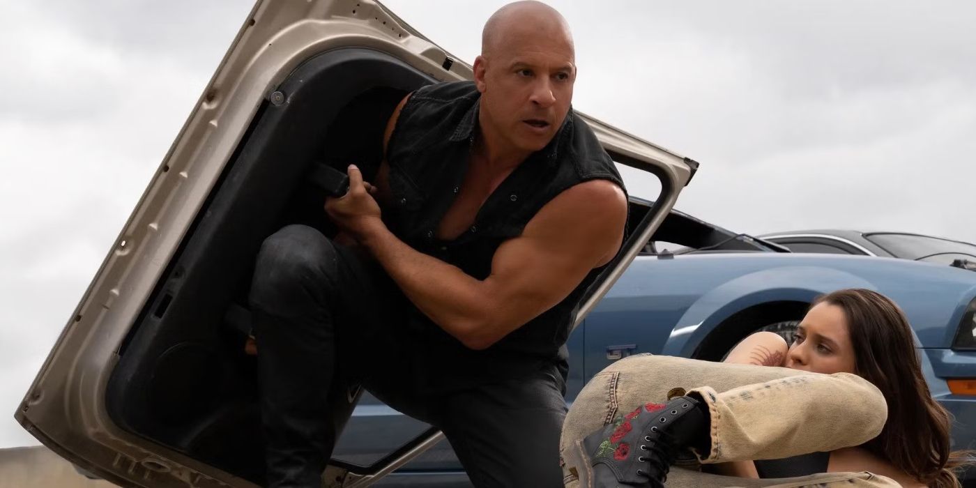 Vin Diesel as Dominic Toretto using a car door as a shield in Fast X