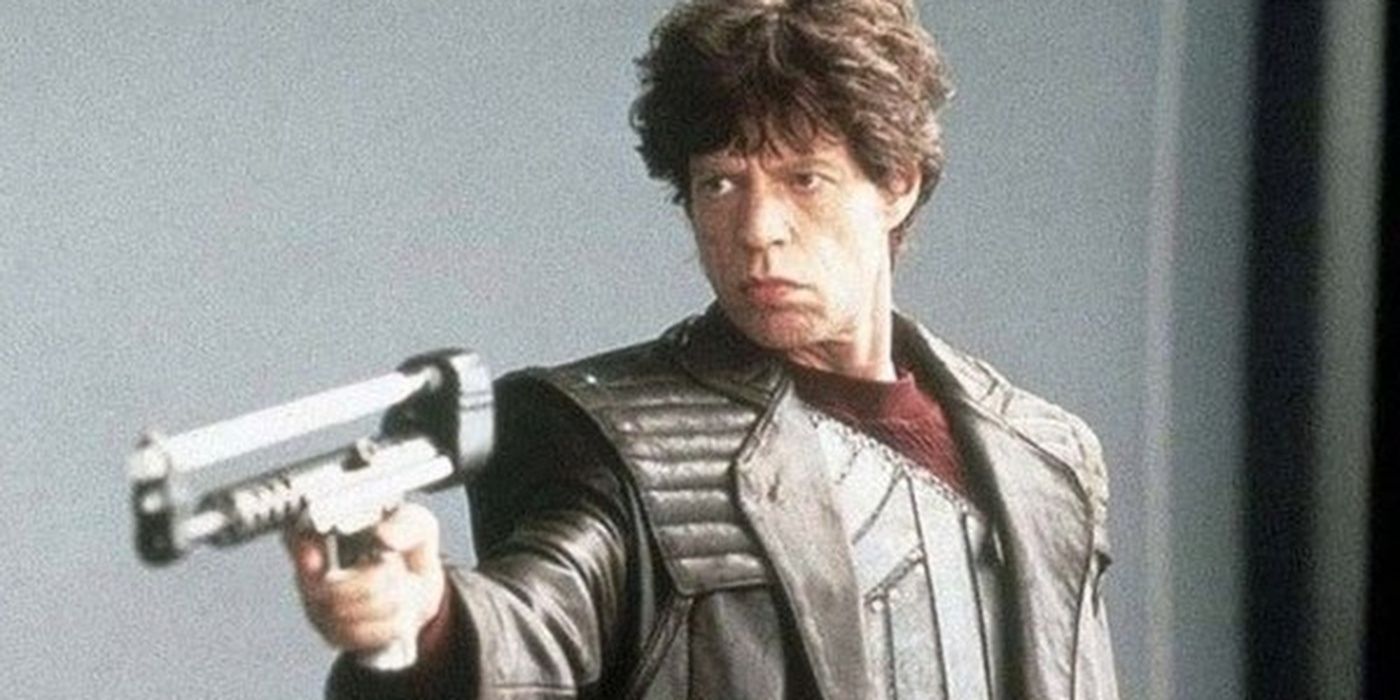 Mick Jagger as Vincent Vecendak, looking serious and aiming a gun in &lsquo;Freejack&rsquo;.