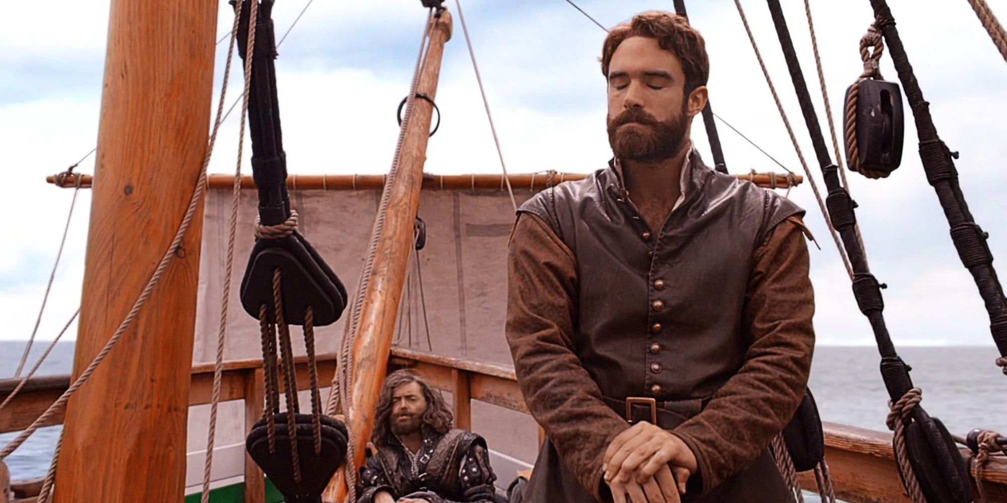 Galavant looking frustrated while Richard curls up on the ground behind him on a pirate ship in Galavant Season 2