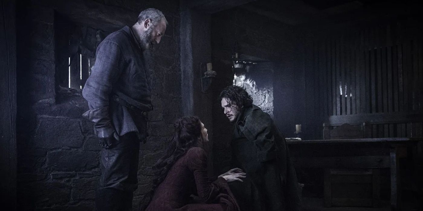 Melisandre keels in front of Jon at talks to him while Davros watches in Game of Thrones