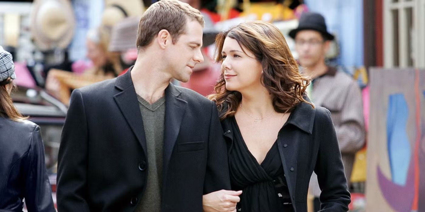 Lauren Graham as Lorelai, David Sutcliffe as Christopher walk and look at each other in Gilmore Girls.