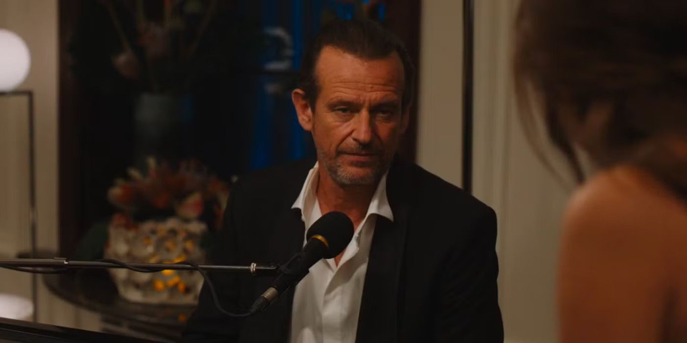 Federico Scribani Rossi as Giuseppe at a piano with a microphone in The White Lotus.