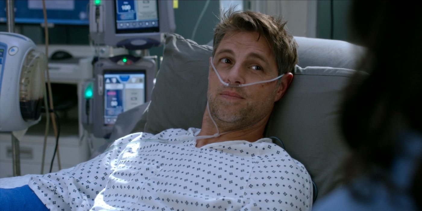 Sam Page as patient Sam Sutton, lying in a hospital bed in Season 19 of Grey&rsquo;s Anatomy