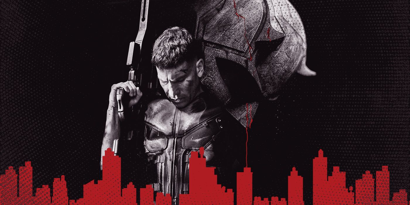 Jon Bernthal as Frank Castle holding a gun in front of a bloody Daredevil helmet