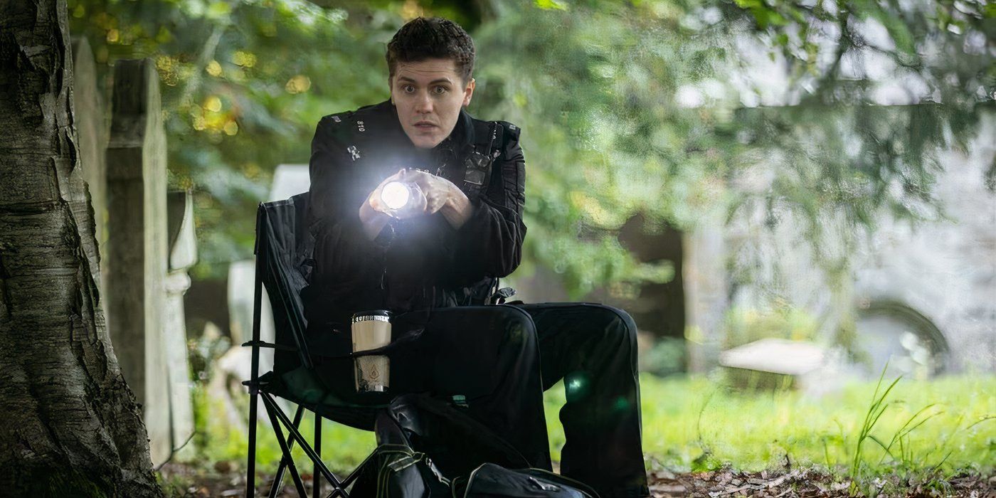 Dylan Llewellyn is pointing a lit torch towards a mystery object in Beyond Paradise Season 3