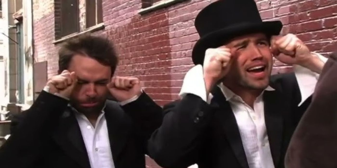 Two of the cast members pretend to cry, wearing top hats and tuxedos in It&rsquo;s Always Sunny in Philadelphia.