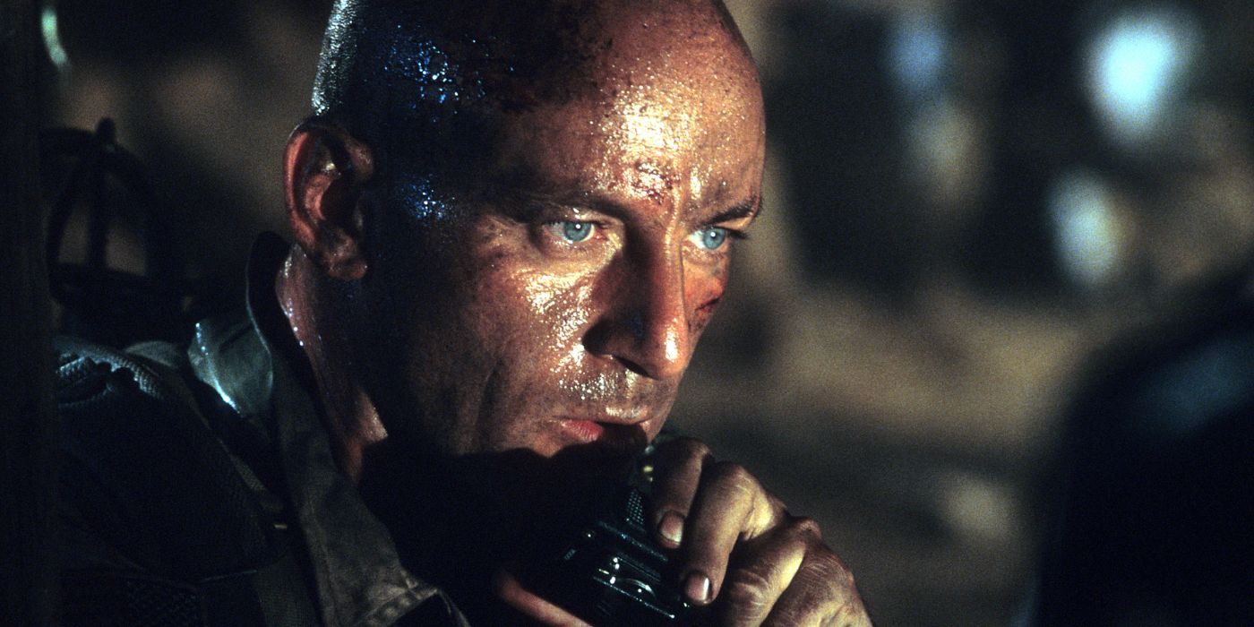Jason Isaacs talking into a walkie-talkie in Black Hawk Down.