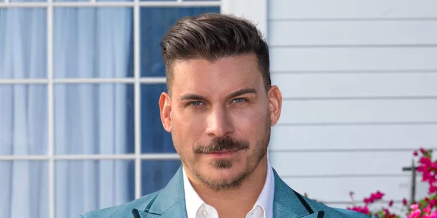 Jax Taylor poses in front of a house in a promotional photo for 'The Valley'